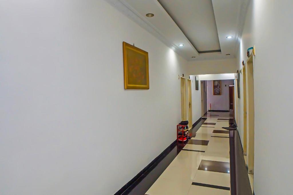 a hallway in a building with a long corridor at OYO 92314 De Coco Guesthouse in Medan