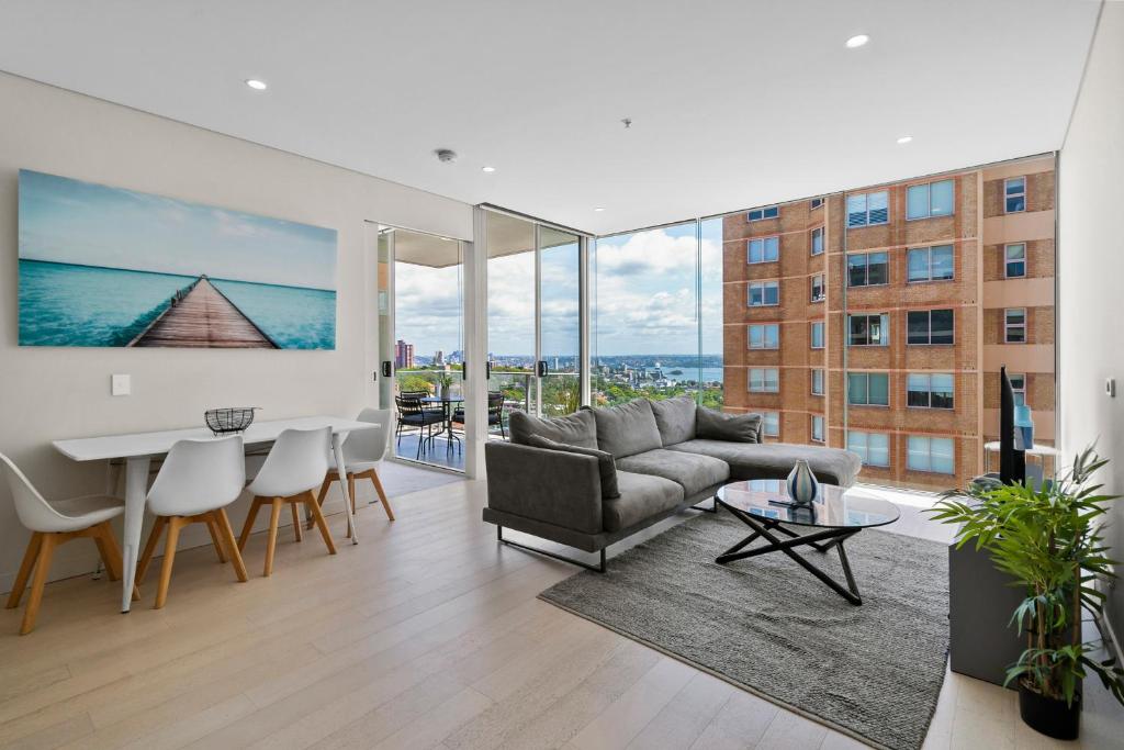 a living room with a couch and a table at Spectacular City & Harbour Views: Bondi Junction in Sydney