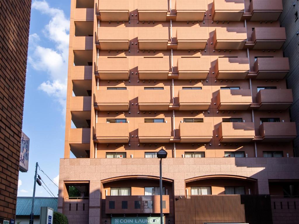 a tall building with balconies on the side of it at Tokyu Stay Monzen-Nakacho in Tokyo