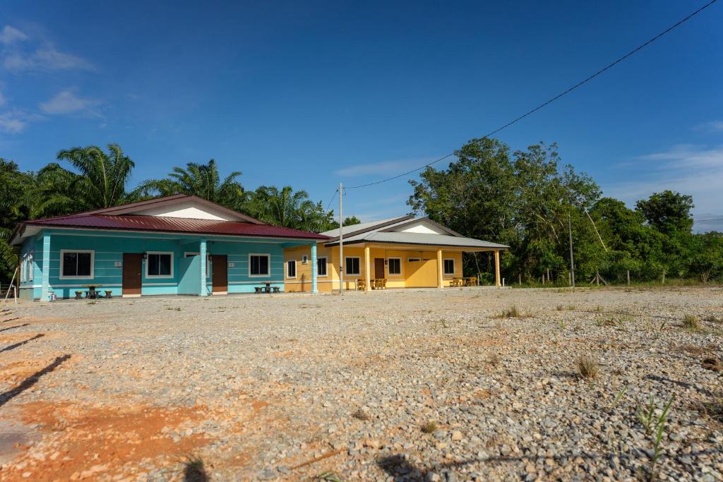 a house in the middle of a gravel field at Tok Umi Guesthouse@AMJ Bakri in Muar