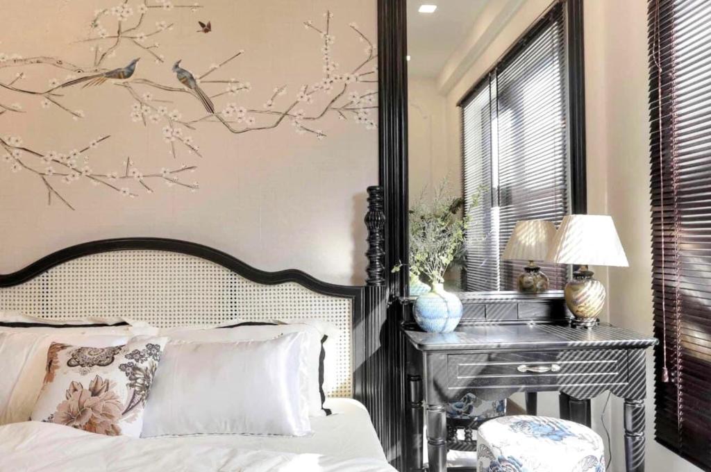 a bedroom with a bed and a desk and a bed sidx sidx sidx at FLC Luxury Apartment Quy Nhon in Quy Nhon