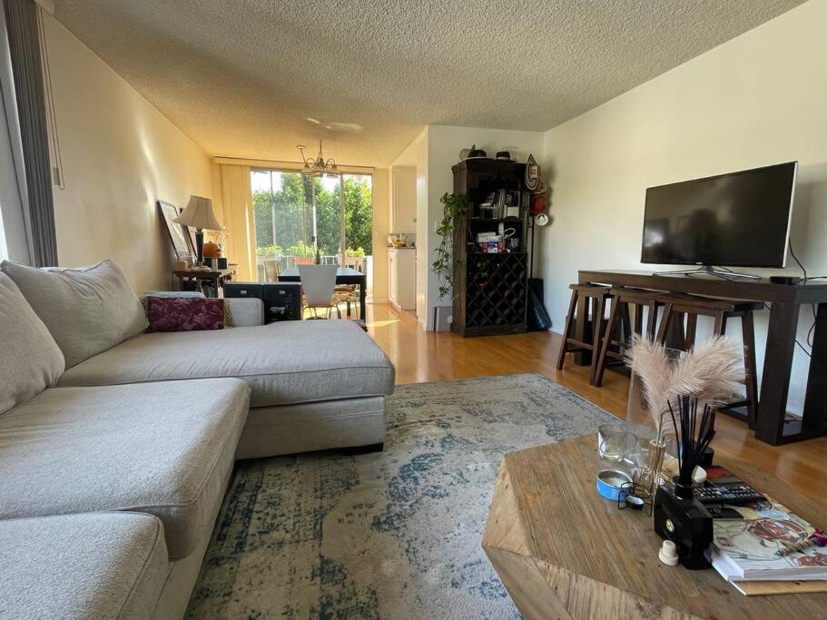 a living room with a couch and a table at Charming and Bright Apartment in Los Angeles