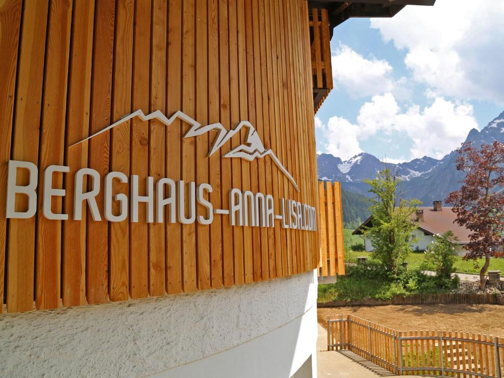 a sign on the side of a wooden building at Berghaus Anna Lisa in Mittelberg