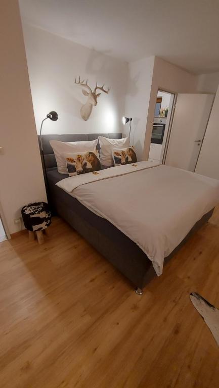 a bedroom with a large bed with two pillows at Ferienwohnung Bergblume in Bolsterlang