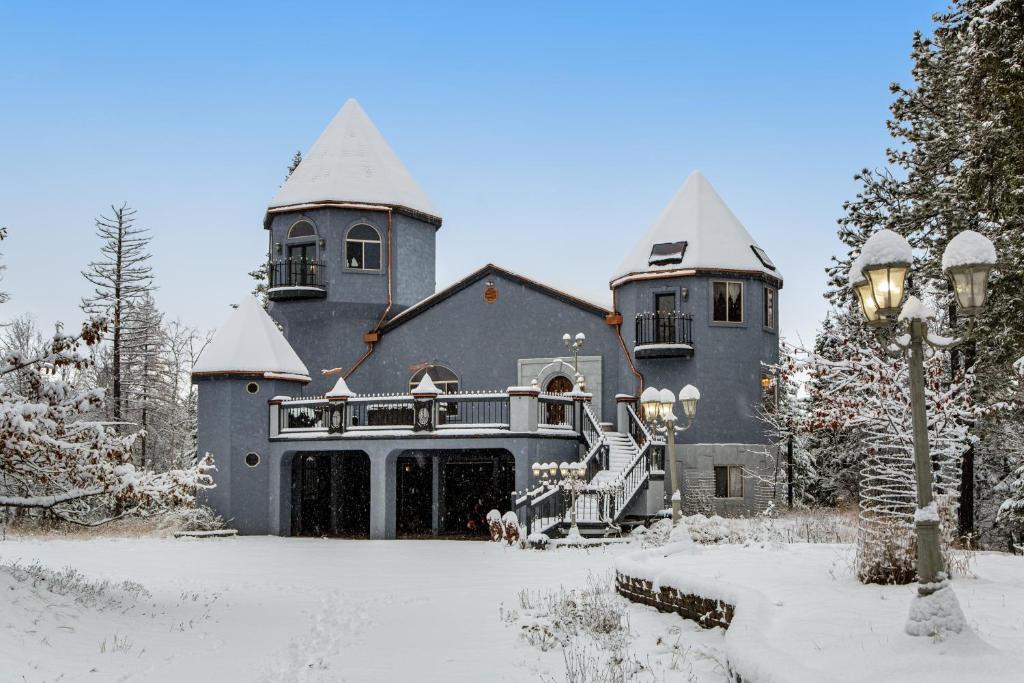 a large house with snow on the ground at The Castle in Columbia Falls