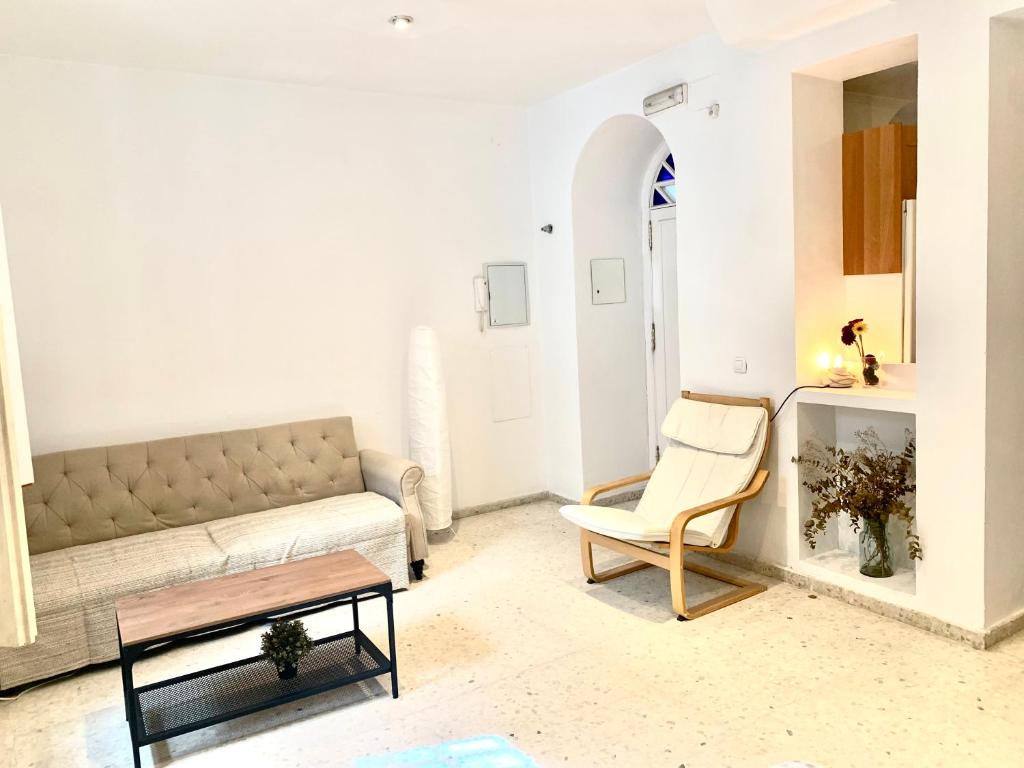 a living room with a couch and a table at Sevilla Central in Seville