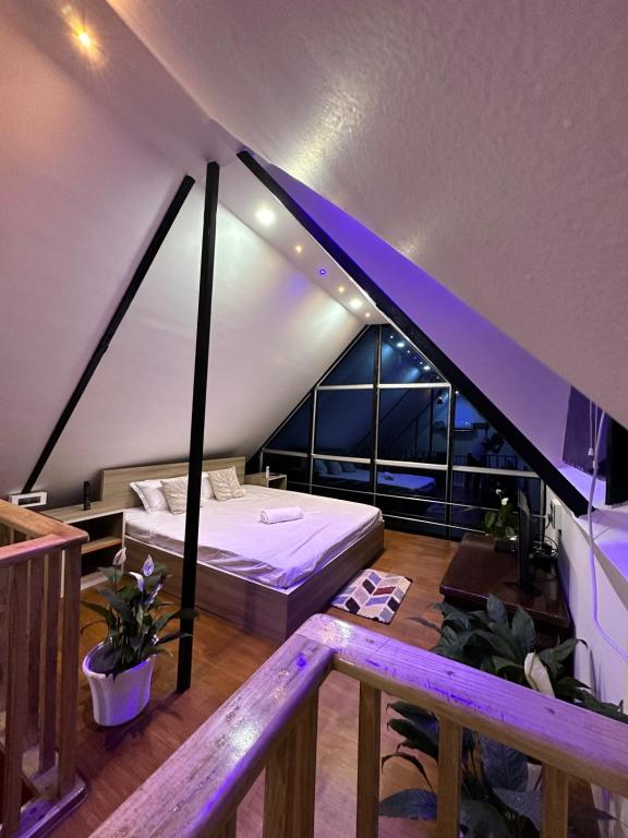 a bedroom with a bed in a attic at Lakeland Homestay Diphu in Diphu