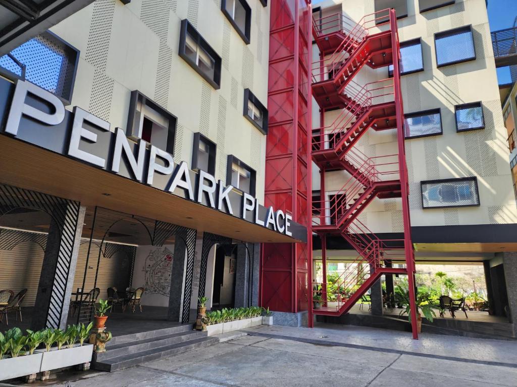 a facade of a building with a red fire escape at Penpark Place in Bangkok