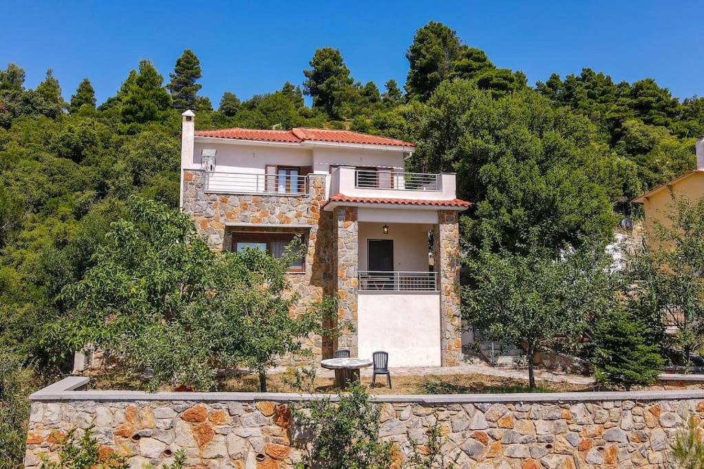 a house on top of a stone wall at Forest View House Seta in Séta