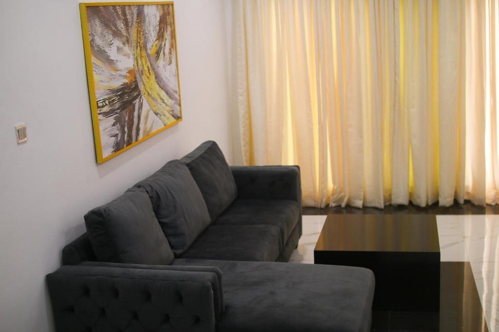 a living room with a couch and a table at Victoria Homes - Lekki Apartment Lekki Phase 1 in Lekki