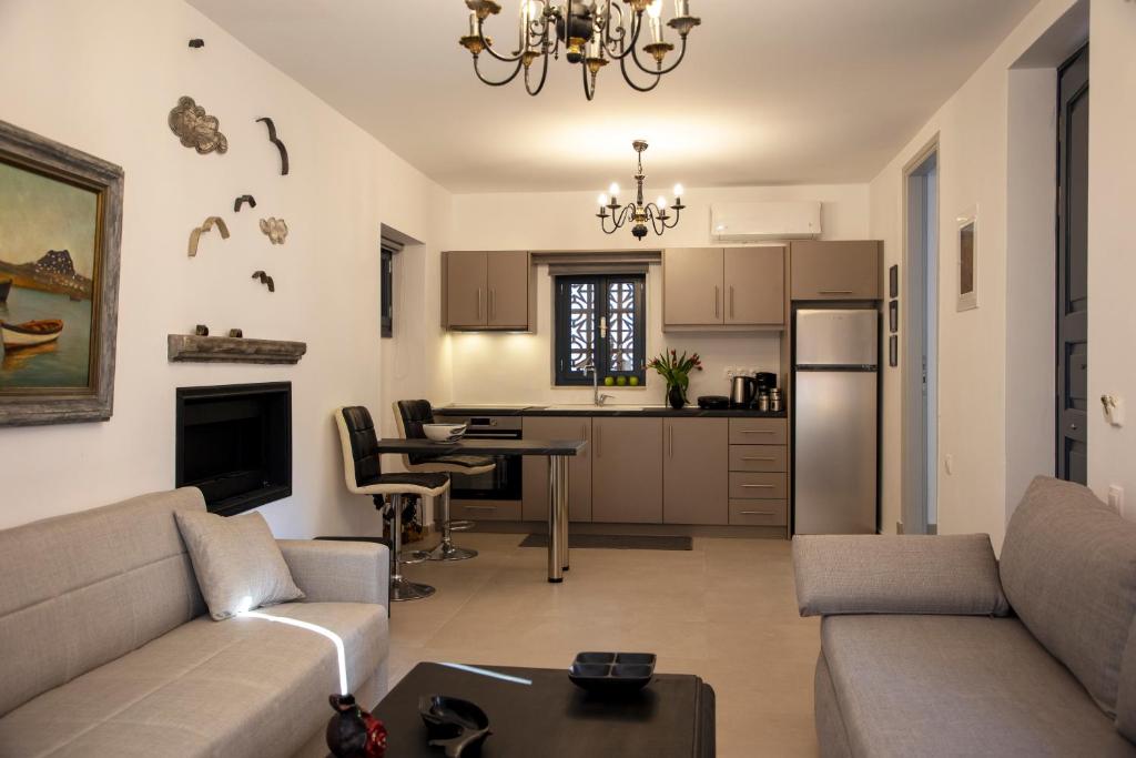 a living room with a couch and a kitchen at Simo's Apartments in Aegina Town