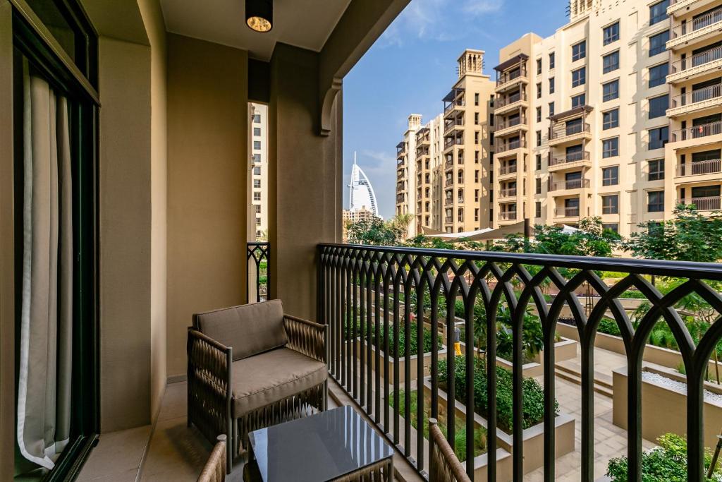 a balcony with a chair and a view of buildings at Madinat Jumeirah Living I Burj Al Arab View I Apartment in Dubai