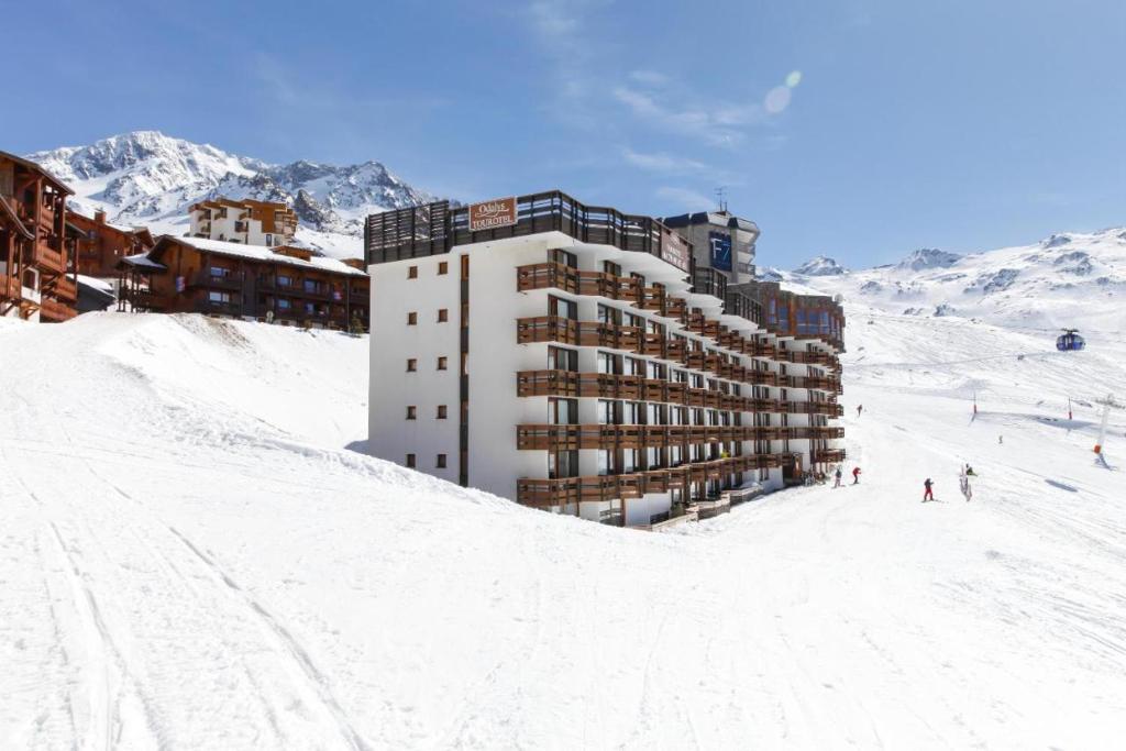 a building on top of a snow covered ski slope at Abrineige Tourotel Val Thorens in Val Thorens