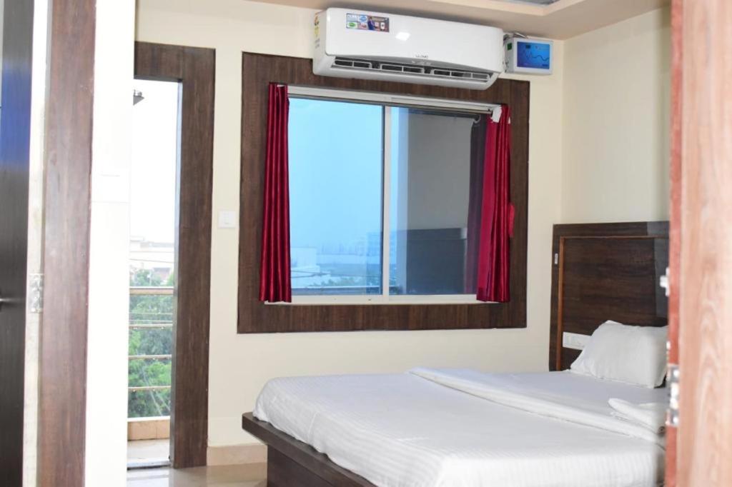 1 dormitorio con cama y ventana en Manorama Beach Resort ! Puri, en Puri