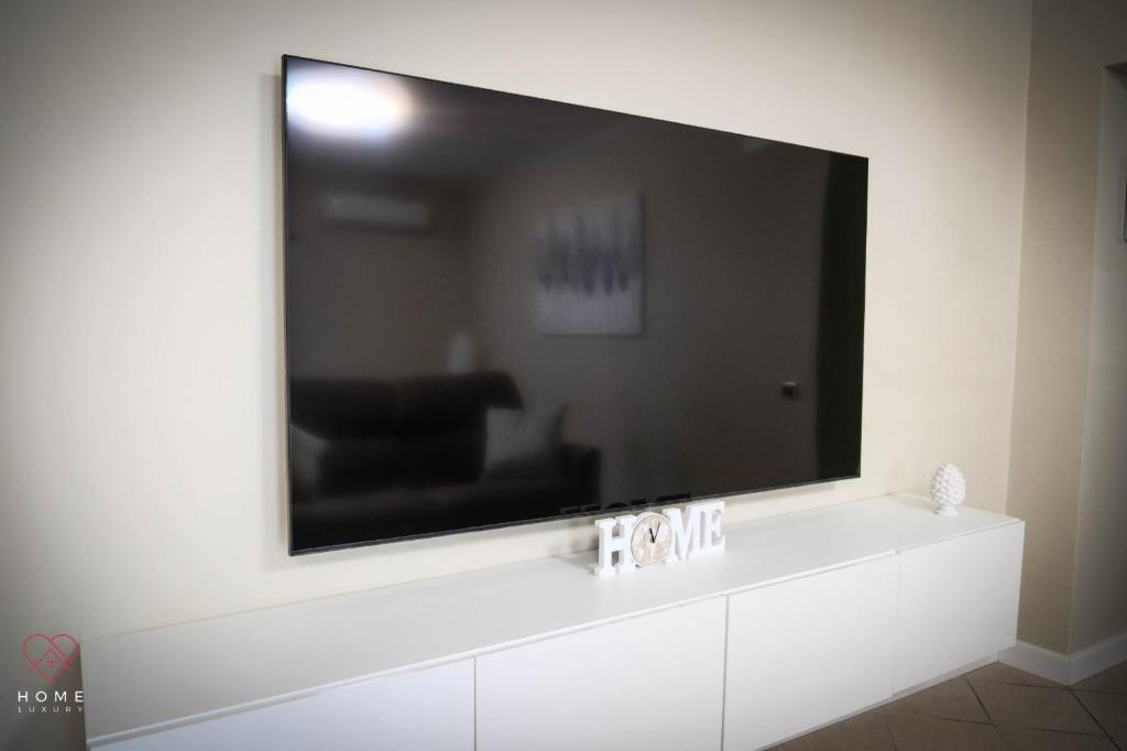 a large flat screen tv on a wall at Home Luxury in Naples