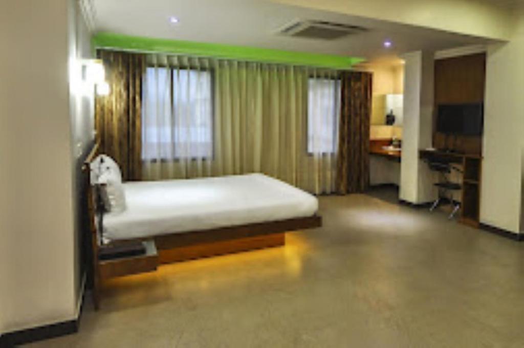 a bedroom with a bed in a room at Hotel Yaiphabaa , Imphal in Imphal