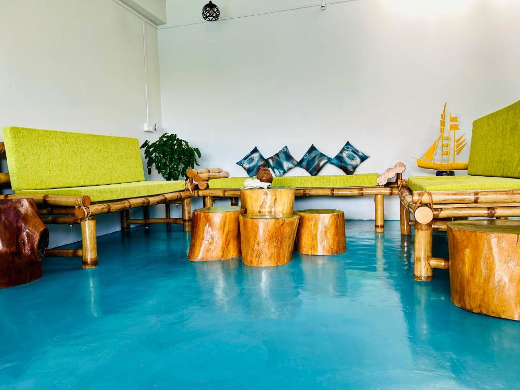 a room with wooden furniture on a blue floor at Bhūma in Havelock Island