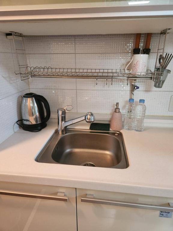 a kitchen counter with a sink in a kitchen at Urban Space Gangnam station in Seoul