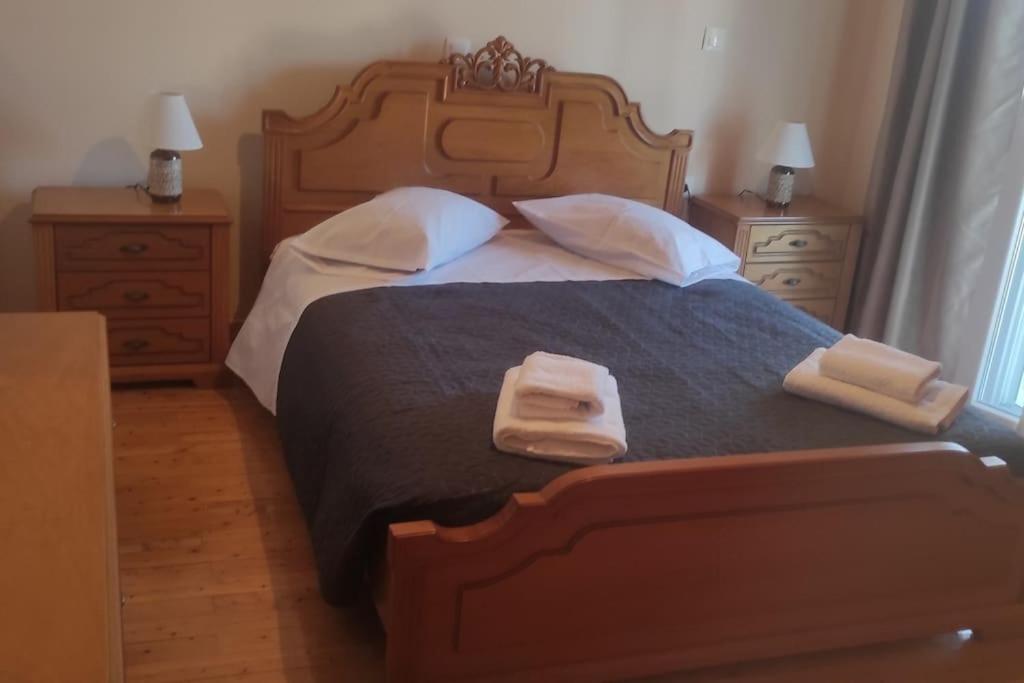 a bedroom with a large bed with two towels on it at Kostas House in Kouspádes