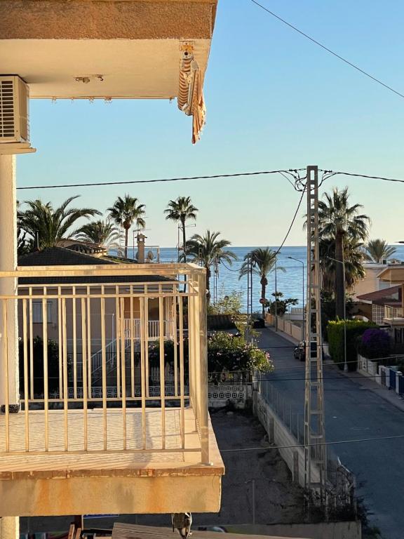 a balcony of a house with a view of the ocean at Amplio apartamento junto al mar in Calabardina