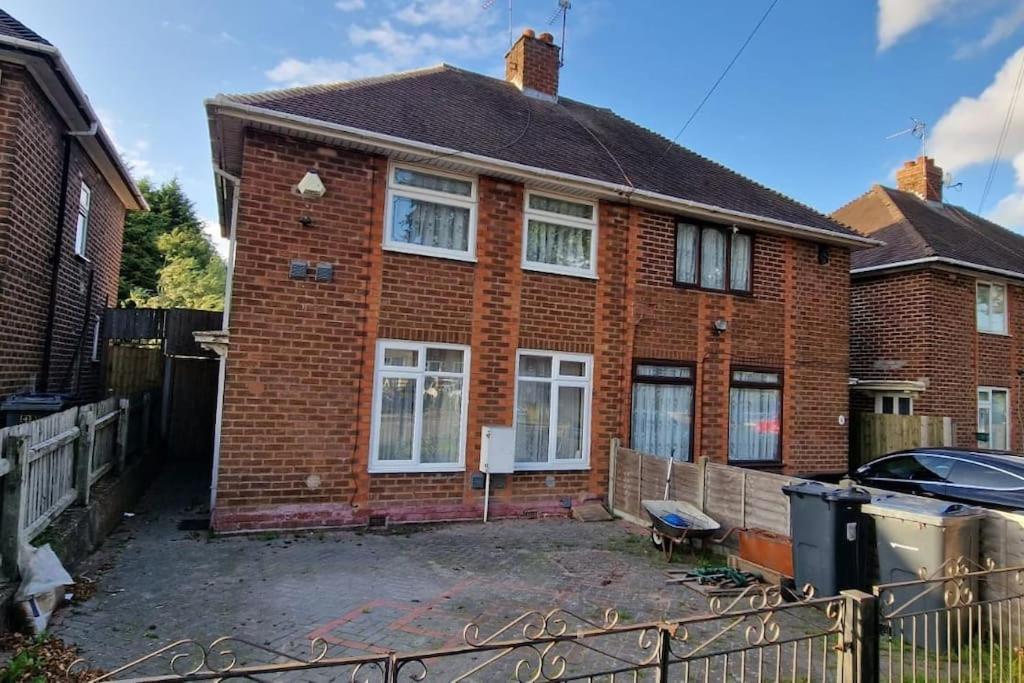 a brick house with a fence in front of it at 3 Bedrooms semi-detached house,near airport,NEC in Birmingham