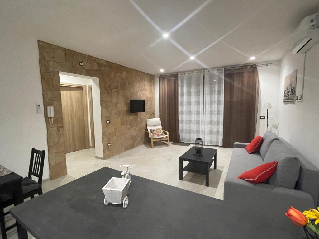 a living room with a couch and a table at La Palma del Nonno in Mazara del Vallo