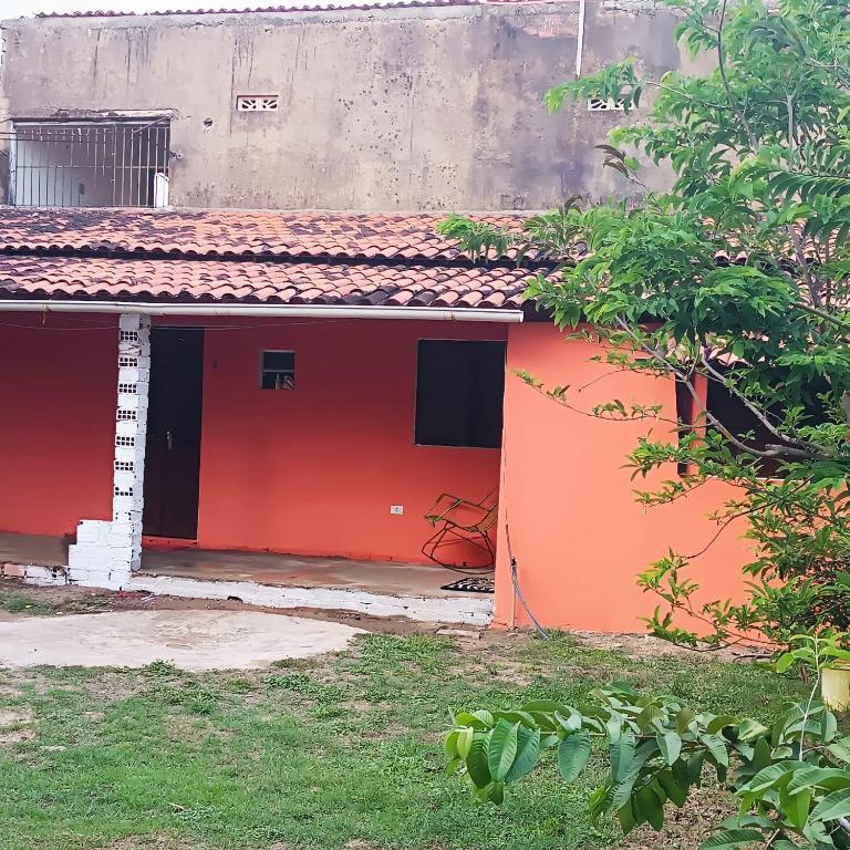 a house with an orange and black at Cantinho da Rosy in Maragogi