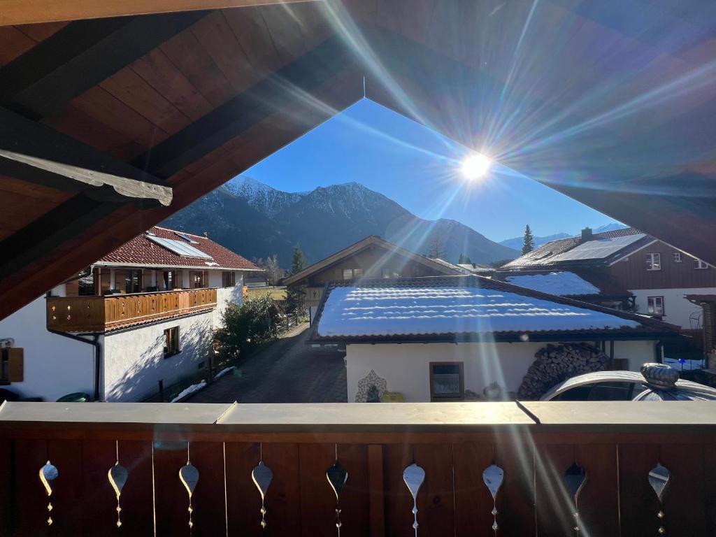 a view from the balcony of a house with the sun at Hexen Haus in Oberau