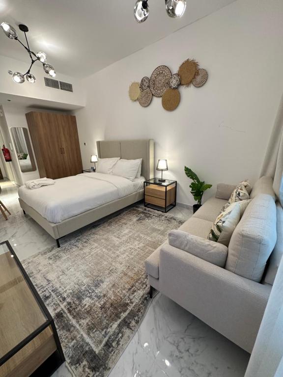 a bedroom with a bed and a couch at Modern Home in Al Qurayyah
