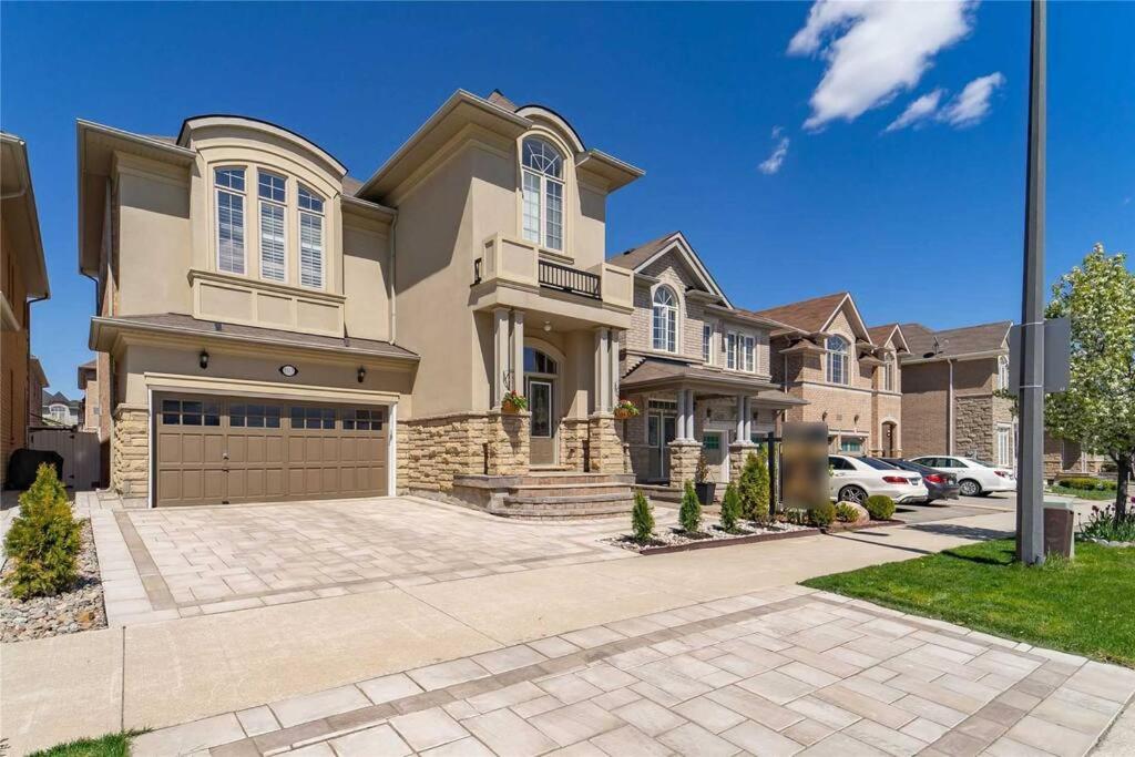 a large house with a garage at Gorgeous Apartment Serene Neighbourhood in Burlington