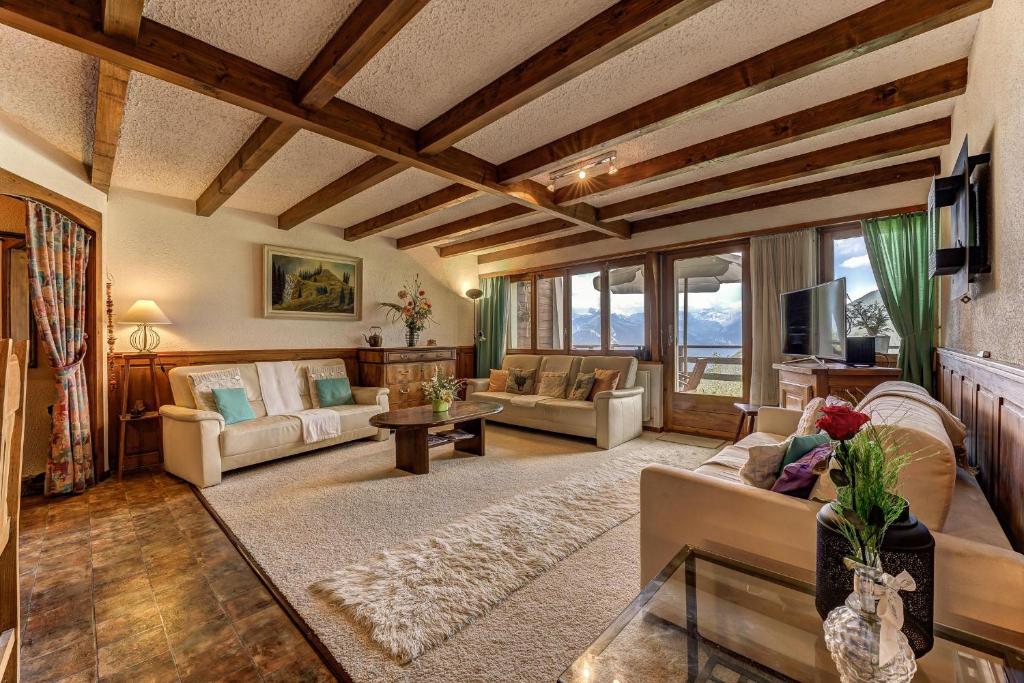 a large living room with couches and a table at Appartement Arolles 701 in La Tzoumaz