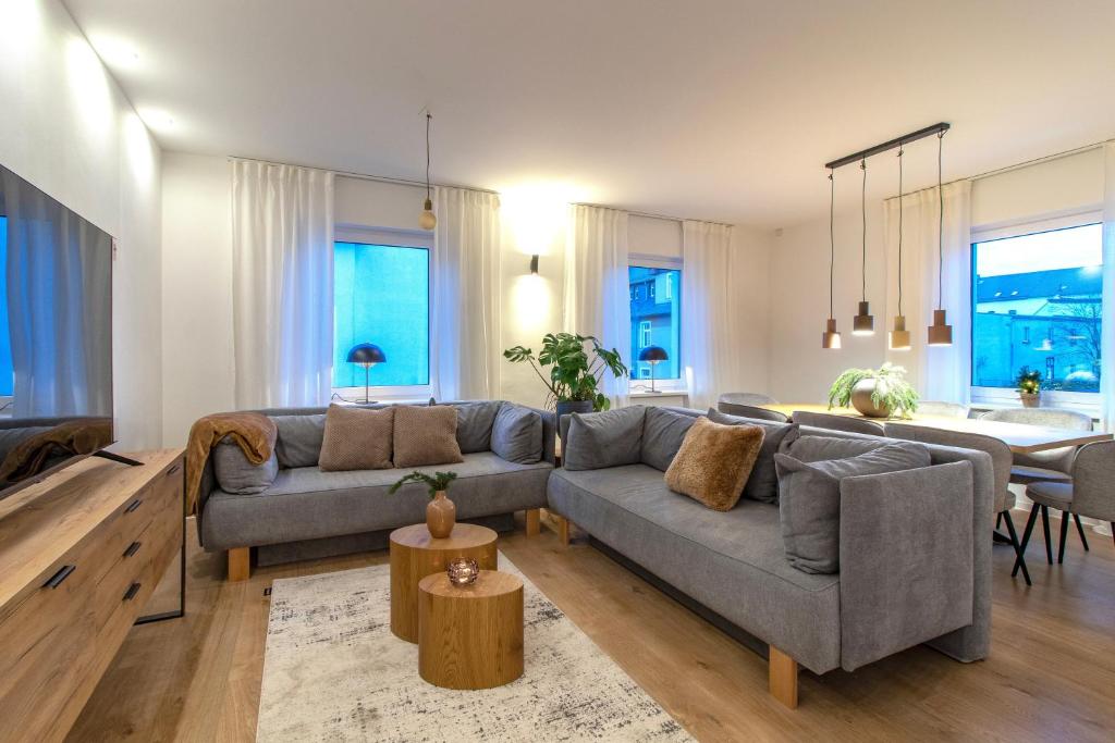 a living room with a couch and a table at Stilvolles City-Apartment I Netflix I WLAN l Stellplatz I Zentral in Schwarzenberg