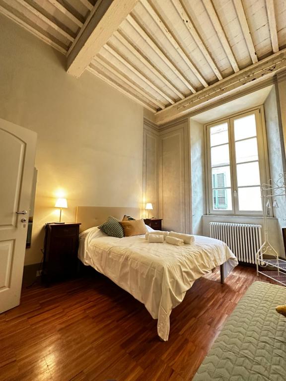 a bedroom with a large bed and a large window at The Street River in Pisa