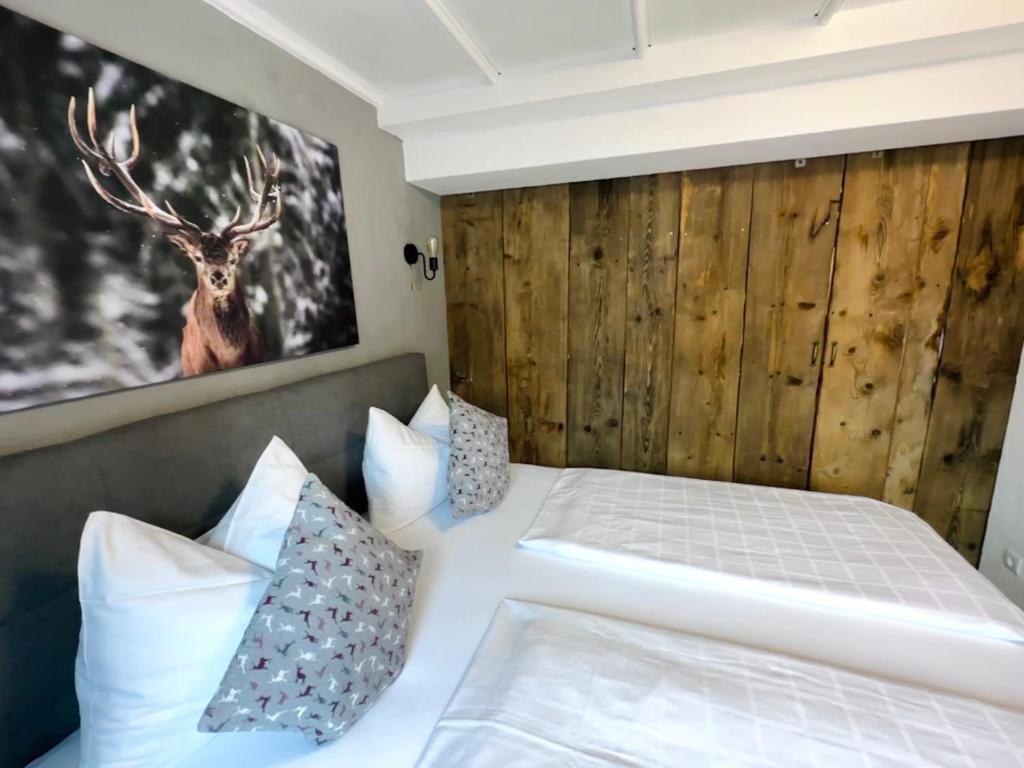 a bedroom with a bed with a deer on the wall at Casa Enrico in Oberjoch