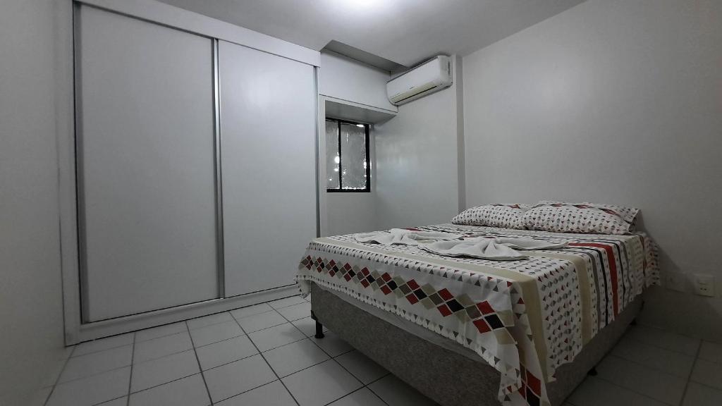 - une chambre avec un lit et une couverture dans l'établissement Apartamento sossegado no Universitário 704, à Caruaru