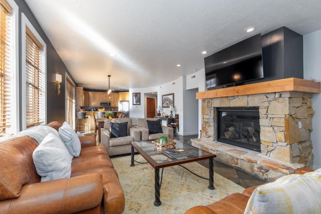a living room with a couch and a fireplace at Town Pointe A105 in Park City