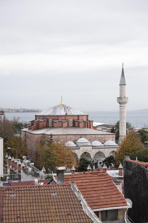 a view of a city with a mosque and roofs at Sareban Hotel Istanbul in Istanbul