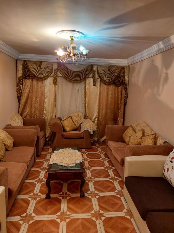 a living room with couches and a chandelier at BLUE Wave in Alexandria