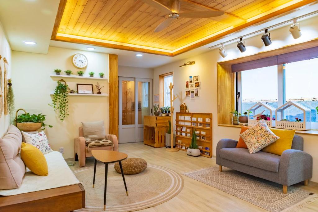 a living room with a couch and a table at I'm Green Stay in Seoul