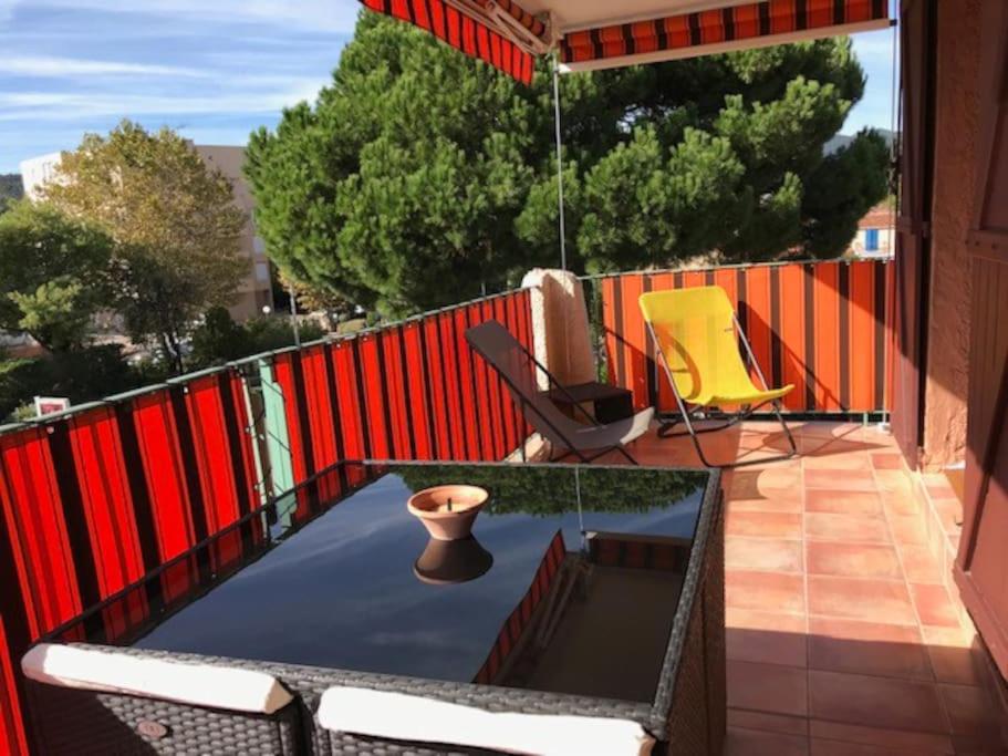 um pátio com uma mesa e cadeiras numa varanda em Espace Sainte-Maxime em Sainte-Maxime