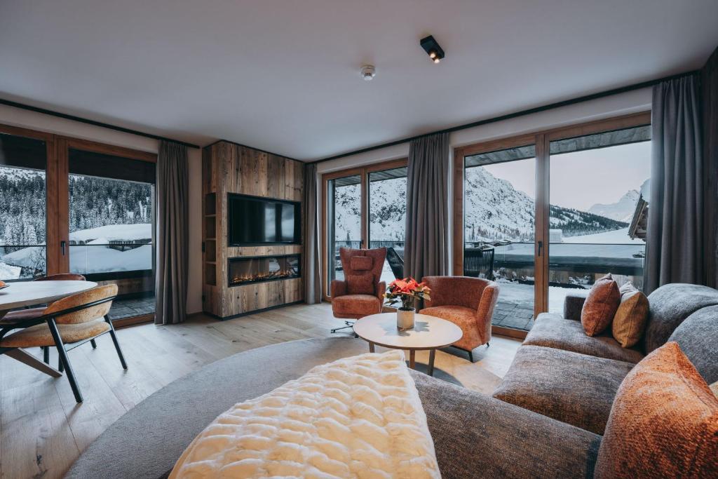 a living room with a couch and a table at Balma Restaurant Apart in Lech am Arlberg