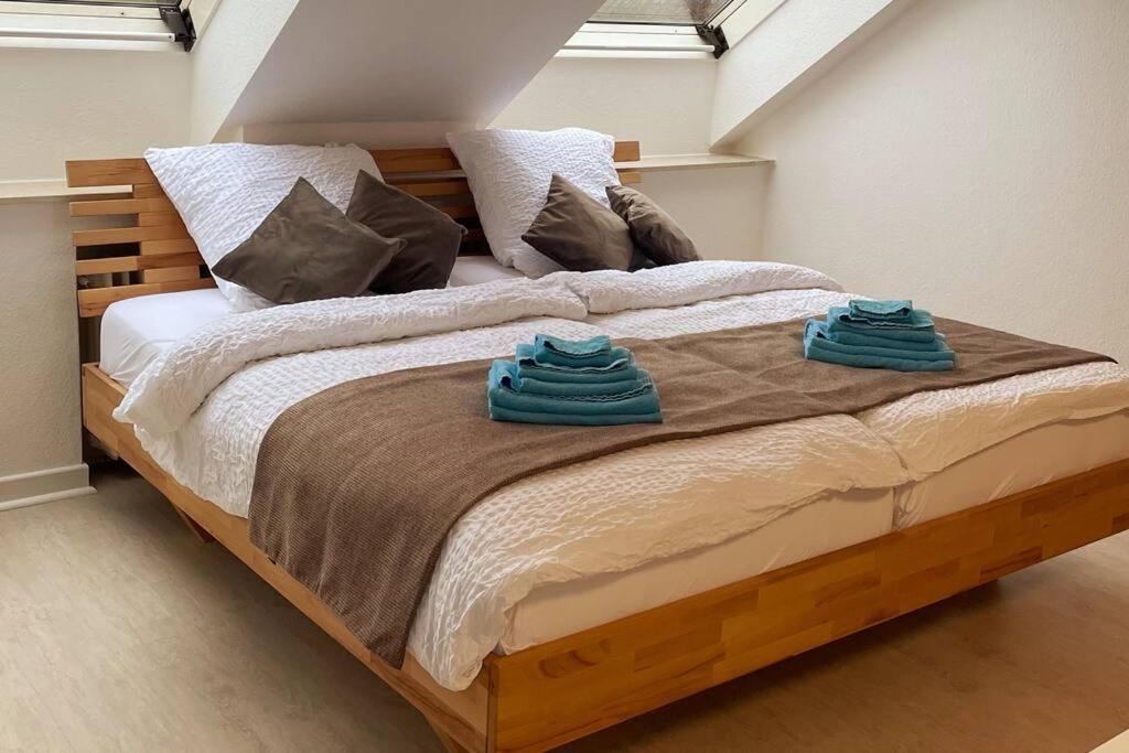 a large bed with two towels on top of it at Appartement im Bielefelder Westen in Bielefeld