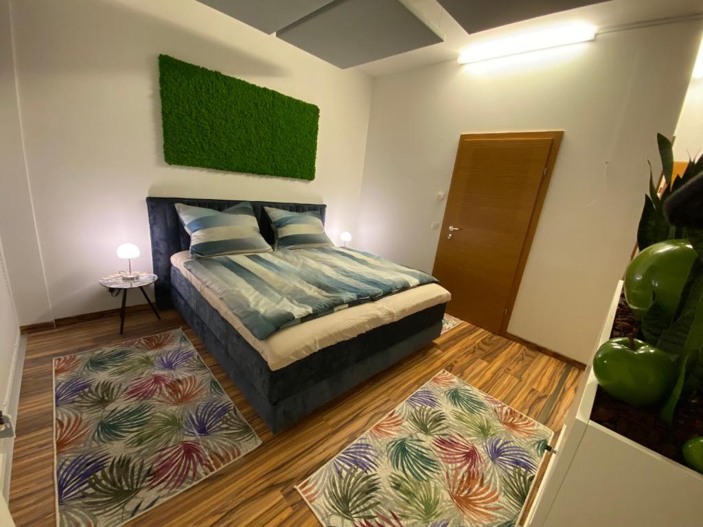 a bedroom with a bed and a rug at „1. SALZBURG work & sleep luxury apartment“ für arbeiten & wohnen ! in Salzburg