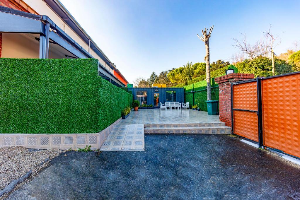 a backyard with an orange fence and a patio at Mia Mia Suites in Istanbul