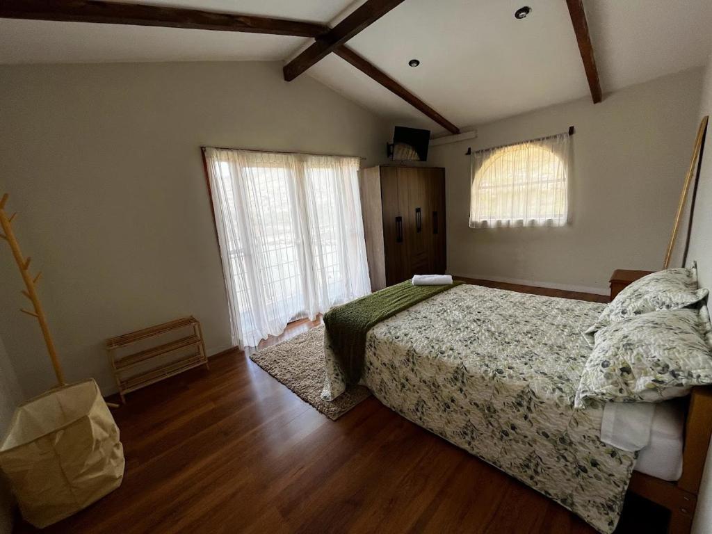 a bedroom with a bed and a large window at Casa San Lorenzo in Huánuco
