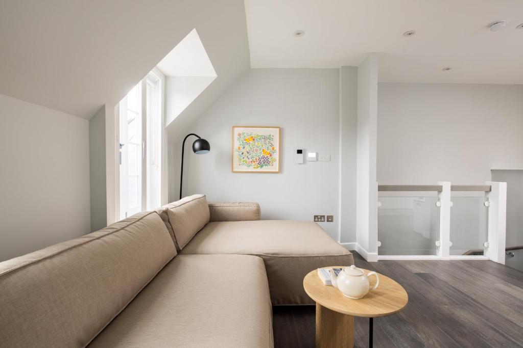 Hotel Hausd - Soho, a living room with a couch and a table at Hausd - Soho in London