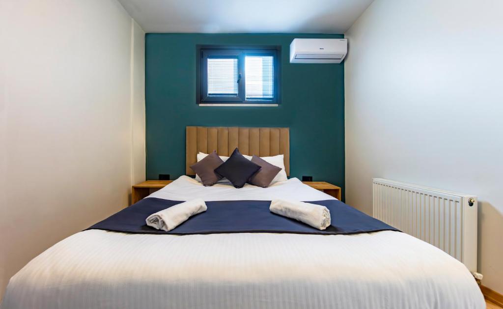 a bedroom with a large bed with blue walls at Mia Mia Suites in Istanbul