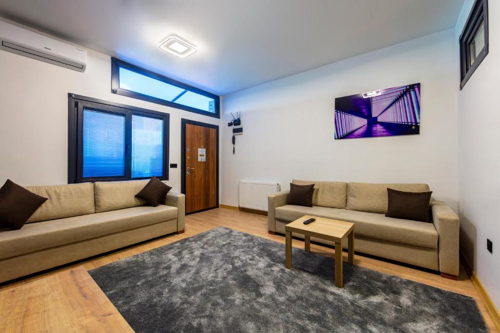 a living room with two couches and a table at Mia Mia Suites in Istanbul