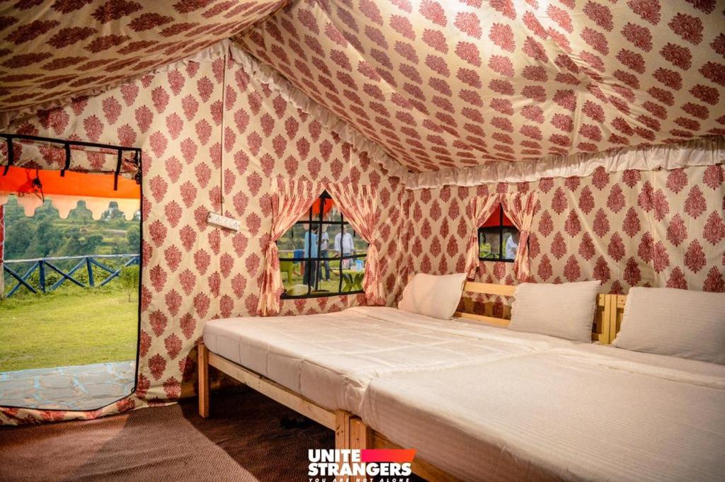 a bedroom with a bed in a tent at Valley view camps &cottages in Nainital