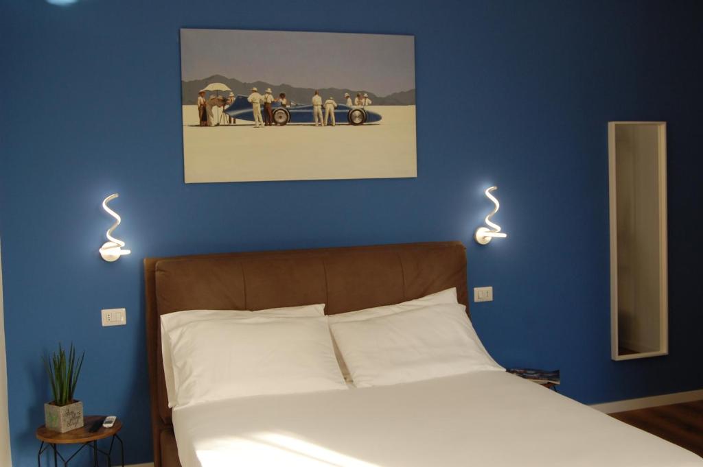 a bedroom with a bed with two lights on the wall at Belltower Elegans in Rome
